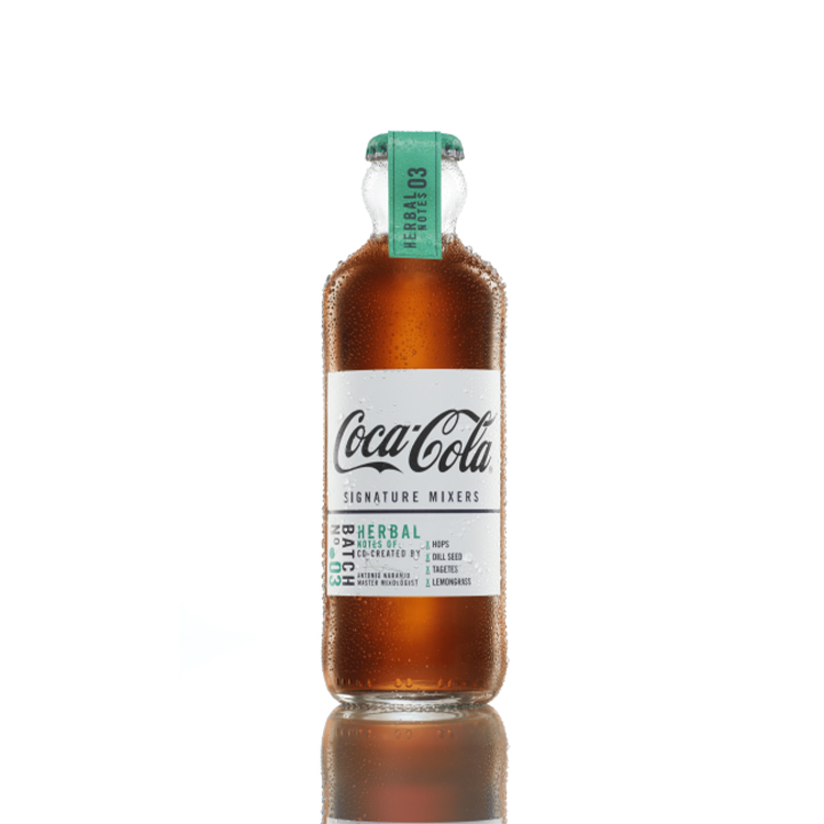 Coca-Cola Signature Mixers Herbal Notes bottle on white background.