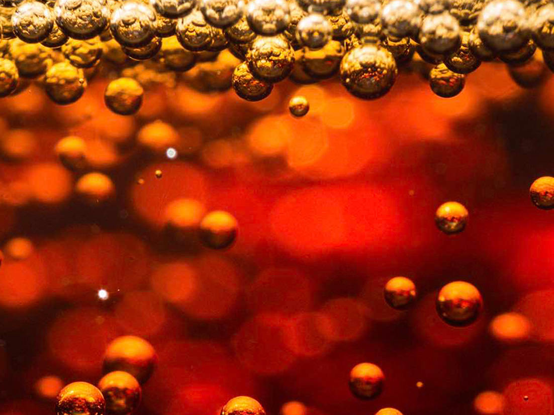 Detail of sparkling bubbles inside a Coca-Cola drink